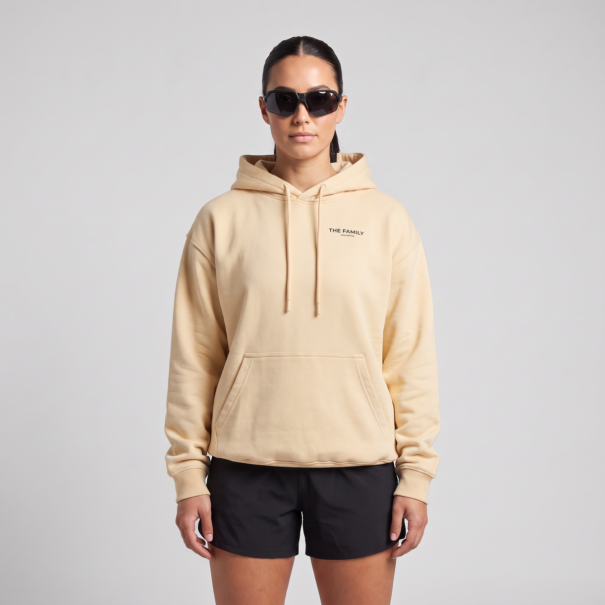 Female model wearing The Family Hoodie in Mild Apricot, front view