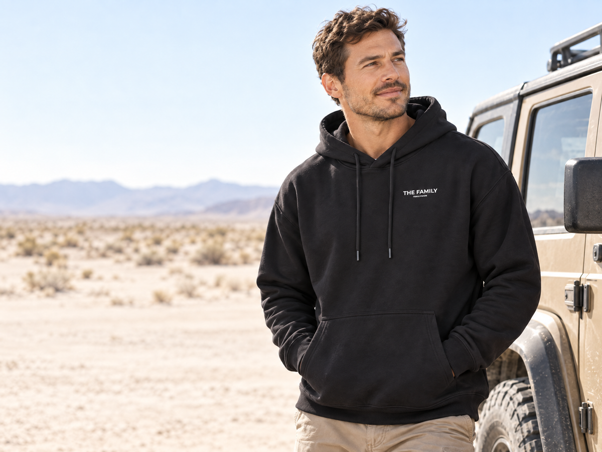 Man wearing the black Trailvision Family hoodie in the desert