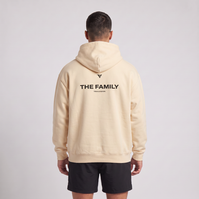 Male model wearing The Family Hoodie in Mild Apricot, rear view with large back print
