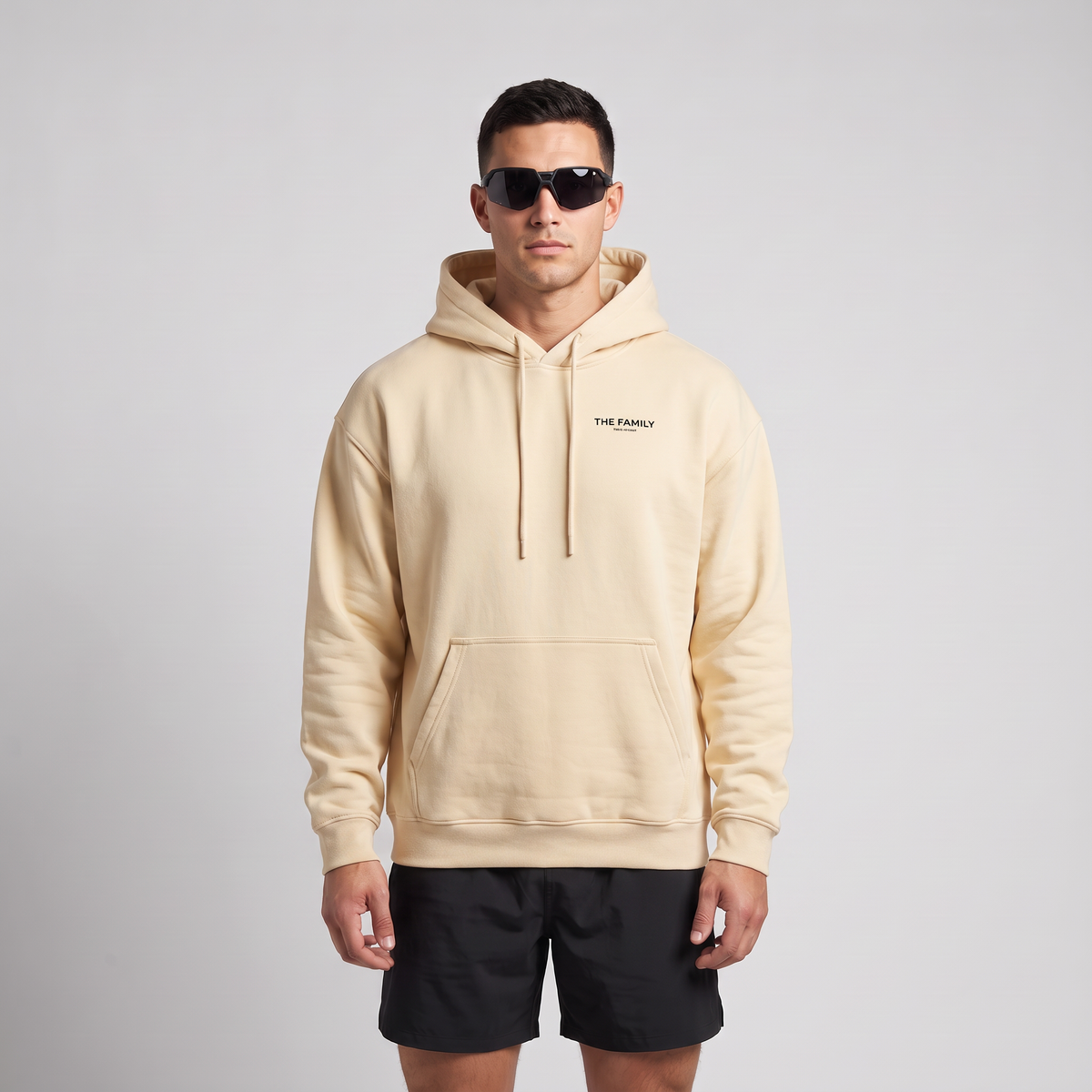 Male model wearing The Family Hoodie in Mild Apricot, front view
