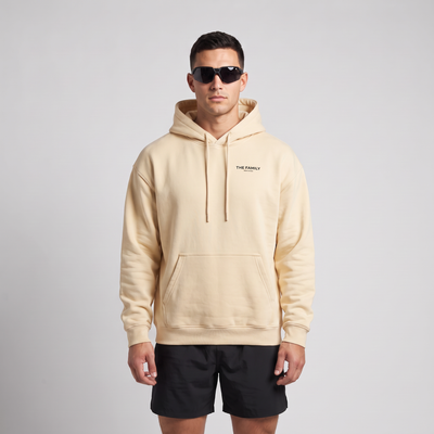 Male model wearing The Family Hoodie in Mild Apricot, front view