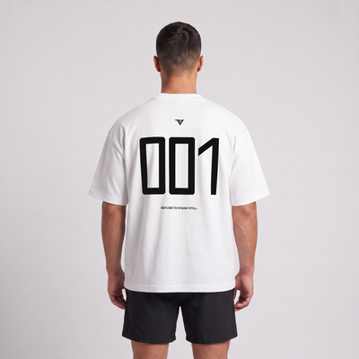 Male model wearing the 001 Oversized Tee in white, rear view with large 001 back print