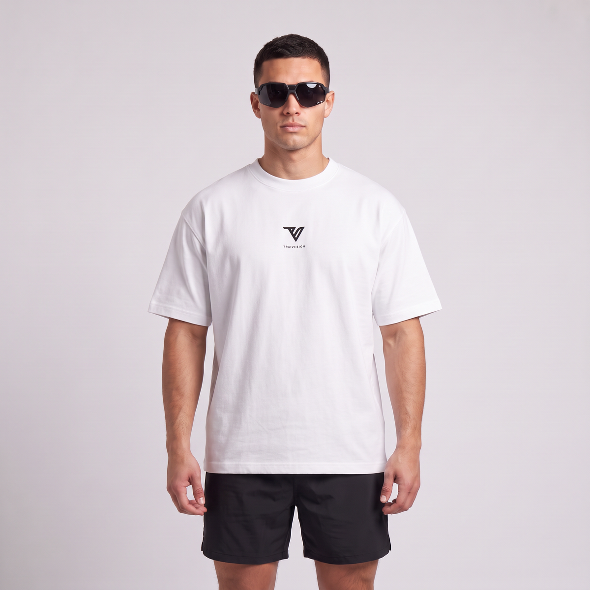 Male model wearing the 001 Oversized Tee in white, front view