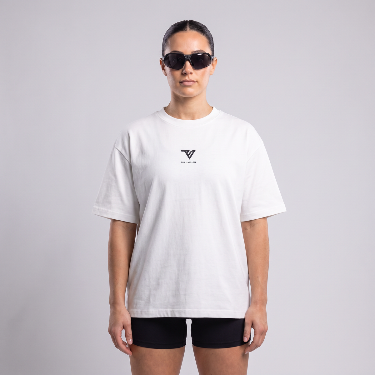 Female model wearing the 001 Oversized Tee in white, front view