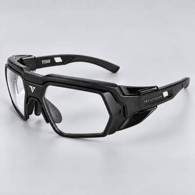 Titan side profile with glossy black side shield and metal TRAILVISION lettering on the matte rubber temple plate